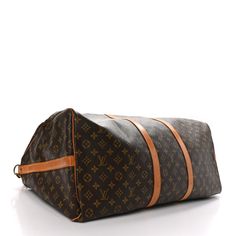 This is an authentic LOUIS VUITTON Monogram Keepall Bandouliere 60. This bag is crafted of signature Louis Vuitton monogram on toile coated dark brown canvas. The bag features a vachetta cowhide leather trim, rolled top handles, an optional shoulder strap, and gold hardware. The top zippers open the bag to a spacious cocoa brown fabric interior. Cocoa Brown, Brown Fabric, Brown Canvas, Authentic Louis Vuitton, Leather Trim, Cowhide Leather, Leather Trims, Louis Vuitton Monogram, Gold Hardware