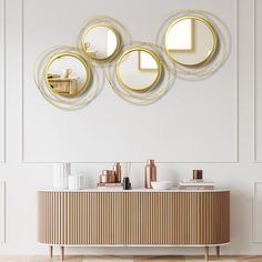 three circular mirrors mounted on the wall above a dresser