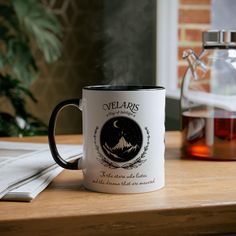 a coffee mug sitting on top of a wooden table