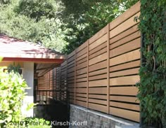 a wooden fence in front of a house