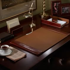 a wooden desk with a coffee cup and book on it