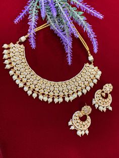 High gold plated designer Tyaani Kundan set with matching Chandbali. Next to real anti tarnish platting, hypoallergenic. Suitable for anything . Can be worn as a necklace or choker. About 1.5 inch wide on the neck. Earring is 2 inch long , push back and very very light weight . Intricate Design Bridal Choker For Festivals, Festival Bridal Necklace With Intricate Design Choker, Intricate Design Kundan Choker Necklace For Celebration, Kundan Choker Necklace With Intricate Design For Celebration, Heavy Temple Choker Necklace For Wedding, Heavy Temple Jewelry Style Bridal Choker Necklace, Heavy Temple Choker Necklace For Festive Occasions, Heavy Temple Jewelry Style Bridal Choker, Heavy Temple Jewelry Bridal Choker Necklace