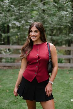 The Nova Vest-Burgundy is the perfect addition to any wardrobe. With its sleek burgundy color, adjustable strap on the back, and button down closure, this vest top is both stylish and functional. Expertly crafted, this vest top offers a sophisticated and polished look for any occasion! 95% polyester, 5% spandex Model is 5'3" with a 32" bust, 25" waist, and 38" hips and wearing a size small. Elegant Sleeveless Top With Back Button Closure, Elegant Workwear Tank Top With Button Closure, Elegant Tank Top With Button Closure For Work, Chic Fall Tank Top With Button Closure, Sleeveless Workwear Top With Back Button Closure, Sleeveless Tops For Work With Back Button Closure, Classic Fitted Tank Top For Fall, Elegant Sleeveless Blouse Tank Top For Fall, Classic Sleeveless Tank Top For Fall