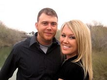 a man and woman standing next to each other in front of a body of water