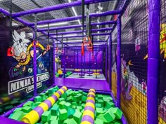 an indoor play area with purple and yellow obstacles