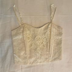 Vintage Victoria’s Secret Bustier Corset Top With Tags Still On! Beautiful Wedding Like Lace And Bead Detail In Perfect Condition, Never Worn. The Back Has Clasps And Consists Of A Stretchy Material Offering Flexibility. The Straps Are Adjustable. As This Is Vintage, The Tags Say Medium/Large For Sizing But I Recommend This For A Size Small. Fitted Delicate Lace Corset, Elegant Cropped Corset With Fitted Bodice, Elegant Cropped Corset With Boned Bodice, Elegant Cropped Corset For Evening, Elegant Cropped Evening Corset, Chic Lace Wedding Corset, Elegant Lace Trim Crop Top For Party, Feminine Delicate Lace Fitted Corset, Elegant Formal Summer Crop Top