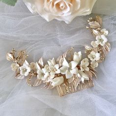 Elegant and romantic, this exquisite hair comb is the perfect accessory for your Special Day. Adorned with a combination of delicate ceramic flowers, iridescent pearls and glowing crystals on a rose gold / silver / yellow gold base, it gives your hair an extra touch of glam to finish off your perfect look on your perfect day. 7" (approx. 17.8cm) wide and 2.5" (approx. 6.35cm) at the widest point. The small comb on the back side will make it easy to attach to your hair and keep it in place. Cast in lightweight alloy and rose gold / silver / yellow gold plated for a flawless finish, the headband is hypoallergenic - lead, nickel and cadmium free. Available in Rose Gold, Silver and Yellow Gold finishes. To make your choice select your preferred finish from the dropdown menu to add to cart. Thi Peony Hair Piece, Flowers Bridal Hair, Bridal Accessories Belt, Hair Accessories Tiara, Flower Girl Jewelry, Floral Hair Pieces, Floral Hair Combs, Iridescent Pearl, Pearl Bridal Jewelry