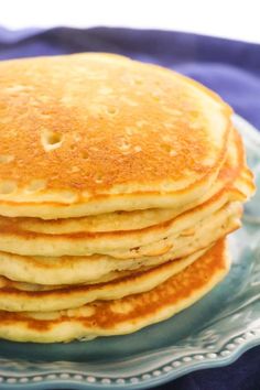 a stack of pancakes sitting on top of a blue plate