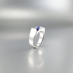 Modern but classic rectangle ring of Lapis Lazuli and Sterling silver. Unique gift for her or him,friend, boyfriend, dad, husband, September and December birthstone, 19 year anniversary. Embedded in the Sterling silver, the blue Lapis Lazuli diagonal stripe brings out its full beauty. This beautiful ring is worked with the technique of inlay, which means the stone is worked seamlessly into the Sterling silver. All our inlay work is real stone, not ceramic stone dust. All our stones are natural s Modern Rectangular Birthstone Jewelry, Modern Silver Rings With Rectangular Stone, Modern Silver Ring With Rectangular Stone, Rectangular Sterling Silver Signet Ring With Gemstone, Minimalist Rings With Polished Finish And Rectangular Stone, Minimalist Rings With Polished Rectangular Stone, Modernist Gemstone Signet Ring As Gift, Minimalist Square Cut Jewelry With Polished Finish, Modernist Rectangular Signet Ring For Anniversary