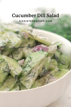 a white bowl filled with cucumber salad on top of a table