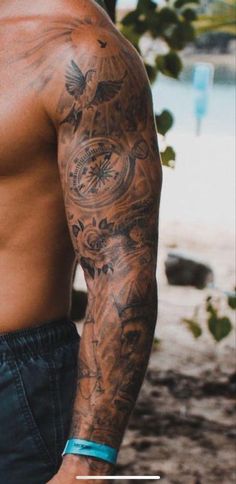 a man with tattoos on his arm and chest