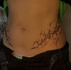 a woman's stomach with vines on it