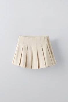 FLOWY PLEATED SKIRT - Sand | ZARA United States Pleated Skirted Skort, Chic Midi Skort With Pleated Details, Asymmetrical Pleated Waist Skirt, Solid Pleated Mini Tennis Skirt, Solid Pleated Asymmetrical Skirt, Solid Color Pleated Mini Tennis Skirt, Trendy Pleated Asymmetrical Skirt, Relaxed Fit Pleated Solid Tennis Skirt, Solid Mini Tennis Skirt With Pleated Waist