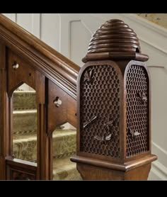 an ornate wooden grandfather clock sitting on top of a set of stairs