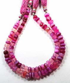 a pink necklace with tassels and beads