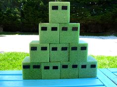 a stack of green cubes sitting on top of a blue table