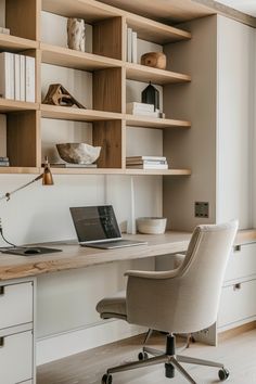 a chair sitting in front of a desk with a laptop on it