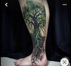 a person with a tree tattoo on their leg