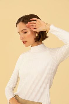 Stay trendy and chic with the Gigi Top. This stylish top features a mock neck and a lettuce frill hem, adding a touch of flair to any outfit. Its versatile design allows for effortless styling, making it a must-have in your wardrobe.