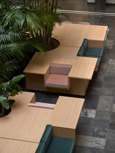 an overhead view of several tables and chairs with plant life in the backround