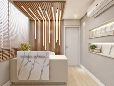 a white marble counter top sitting under a wooden slatted wall next to a window