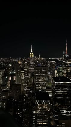 an aerial view of the city at night with lights and skyscrapers in the background