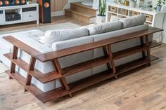 a living room filled with furniture and lots of wooden flooring on top of a hard wood floor