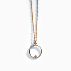 "A symbol of never ending love, our modern open circle necklace is elevated by a tiny floating diamond CZ, set inside the curve. 1.1mm fine gold filled chain with circle measuring 15mm. | Specifications | Material: 14k gold filled Pendant: 1.5cm wide Length: 16\" | 18\" Packaging: Jewelry comes in brand embossed box. | What is 14k gold filled? | 14k gold fill is a fantastic alternative to solid gold as it is a genuine layer of gold permanently bonded onto base metal with heat and pressure. It is Modern Necklace With Single Diamond In Round Pendant, Modern Necklace With Single Diamond On Round Pendant, Modern Necklaces With Single Diamond Round Pendant, Modern Necklace With Single Diamond And Round Pendant, Everyday Round Necklace With Single Diamond, Modern Round Charm Necklace For Everyday, Modern Round Charm Necklace, 14k Gold Delicate Circle Chain Necklace, 14k Gold Delicate Circle Necklace