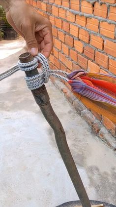 a person holding onto a rope attached to a fire hydrant on the side of a building