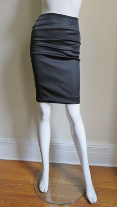 For Sale on 1stDibs - A gorgeous black stretch silk skirt from Dolce & Gabbana. It is a pencil style skirt with horizontal ruching across the front and back. There is functional Fitted Ruched Draped Skirt For Evening, Fitted Draped Skirt With Ruched Detail For Evening, Evening Fitted Draped Skirt With Ruched Detail, Black Draped Skirt For Cocktail, Ruched Mini Skirt For Evening, Chic Evening Skirt With Ruched Details, Chic Ruched Evening Skirt, Chic Evening Ruched Skirt, Elegant Ruched Skirt For Night Out