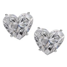 These exquisite diamond stud earrings feature two mesmerizing heart cut diamonds, with a combined weight of 4.01 carats, weighing 2.00 and 2.01 carats respectively, set in refined 18K white gold. The diamonds display exceptional color grades of E and F, radiating near-colorless brilliance that captivates the eye. With clarity grades of VVS2 and VS1, they showcase remarkable purity, ensuring a pristine and luminous appearance. The excellent polish enhances the surface to a mirror-like finish, all Heart Cut Diamond Earrings, Heart Shaped Diamond Earrings, Diamond Earrings Studs Round, White Gold Studs, White Gold Earrings Studs, Heart Shaped Diamond, Fine Jewels, Modern Earrings, Pearl Stud Earrings