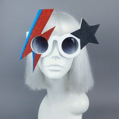 David Bowie inspired novelty sunglasses. These are customised UV400 sunglasses so you can wear them outside at a festival or wherever you like. They sparkle in the sunlight. Needless to say, they are utterly fabulous... and not for the faint-hearted! Measurements: 78 grams About 21cm from widest point to wid These sunglasses are large so they don't come in a sunglasses case, basically, they don't make sunglasses cases this big! These sunglasses are for adults (not children), there are points on Retro Plastic Festival Sunglasses, White Tinted Festival Sunglasses, White Festival Sunglasses For Summer, White Sunglasses For Summer Festival, Summer Festival White Sunglasses, Glam Rock Fashion, Novelty Sunglasses, Aladdin Sane, Uv400 Sunglasses