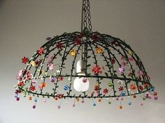 an apple is hanging from a birdcage decorated with flowers