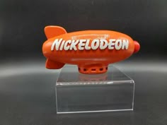 an orange toy airplane with the word nicelodeon on it's side