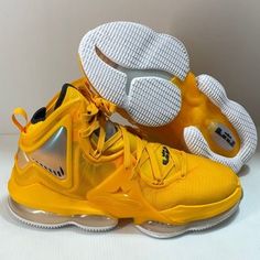 a pair of yellow sneakers with white soles