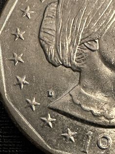 a close up of a coin with stars on the front and back of it's face