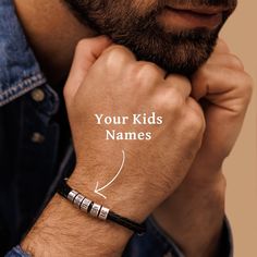 a man wearing a bracelet with the words your kids names on it