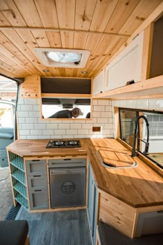 the interior of a small camper with wood paneling and white brick wallpaper