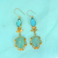 Sky Blue Topaz Earrings- Aqua Crackle Glass Gemstone Earrings- Gold Plated Drop Earrings- Topaz Jewelry- Fashion Earrings for Women Description : Metal : Brass Plating : Gold Plated Stone : Sky Blue Topaz Hydro and Aqua Crackle Glass Length : 70 x 17 mm Approx Weight : 11.46 Gram Approx Stone Size : 16 x 7 mm approx marquise topaz, 17 x 13 mm approx oval crackle glass ❣❣ Handmade Item ❣❣ **Made to Order** » G EM S T O N E D E T A I L « **Gemstone structure may vary from the image as two gemstone Elegant Turquoise Danglers As A Gift, Elegant Turquoise Danglers For Gift, Elegant Blue Drop Earrings, Elegant Blue Drop Danglers, Blue Elegant Handmade Danglers, Handmade Blue Elegant Danglers, Blue Danglers For Gift, Handmade Blue Drop Earrings, Dangle Earrings Gold