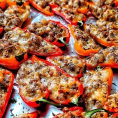 stuffed bell peppers with meat and cheese are on a baking sheet, ready to be eaten