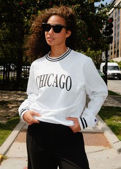 a woman wearing sunglasses and a chicago sweatshirt