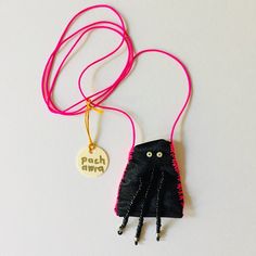 a black bag with pink string attached to it and a tag that says fetch paws