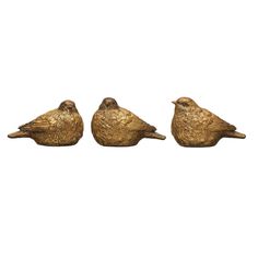 three birds sitting on top of each other in front of a white background and one is gold