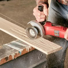 a man using a power drill to cut wood