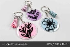 three key chains with different designs on them