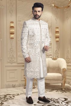 Crafted with intricate pearls and thread embroidery, the Mens Sherwani- U2-S350 is an exquisite choice for grooms. Its elegant design exudes sophistication, making it perfect for weddings. Elevate your wedding ensemble with this impeccable piece. Designer Formal Traditional Wear With Chikankari Embroidery, Designer Traditional Wear With Chikankari Embroidery For Formal Occasions, Designer Chikankari Embroidery Formal Traditional Wear, Designer Chikankari Embroidery Traditional Wear For Formal Occasions, Elegant Fitted Kurta With Pearl Embroidery, Elegant White Kurta With Pearl Embroidery, Eid Wedding Traditional Wear With Pearl Embroidery, Traditional Wear With Pearl Embroidery For Wedding Eid, Elegant Kurta With Pearl Embroidery In Traditional Drape