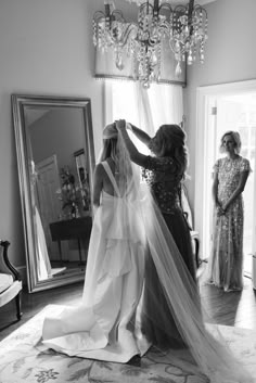 the bride is getting ready to walk down the aisle in her wedding dress and veil