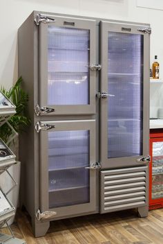 a large metal refrigerator sitting on top of a hard wood floor