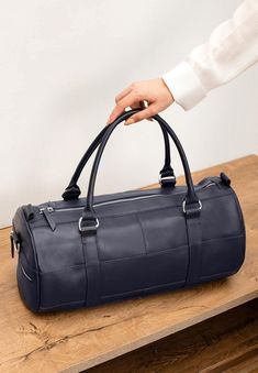 Unveil the epitome of elegance and practicality with our Dark Blue Luxury Weekend Bag. Crafted from premium full-grain leather, this handmade travel masterpiece is your ultimate companion for weekend getaways, gym sessions, or daily endeavors, all while elevating your masculine charm.Here's why this Weekend Bag stands out:High-Quality Full-Grain Leather: Experience durability and a touch of luxury with the finest leather.Detachable Long Strap: Enjoy versatility and comfort in carrying, tailored Luxury Navy Leather Satchel, Luxury Blue Bags With Smooth Grain, Luxury Blue Smooth Grain Bag, Luxury Navy Leather Shoulder Bag, Blue Travel Bag With Smooth Grain, Modern Blue Bags For Business Trips, Luxury Blue Bags For Business Trips, Navy Leather Bag With Luggage Sleeve, Blue Leather Duffle Bag For Daily Use