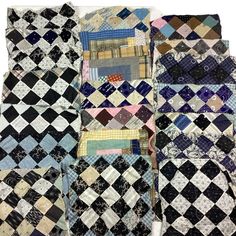 a pile of quilts sitting next to each other on top of a white surface